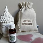 Rose quartz face and body gua sha set with massage oil and cotton pouch by Cupping in the City.
